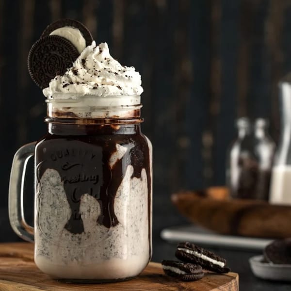 Ranoush's Oreo milkshake in a mason jar, topped with whipped cream and an Oreo cookie.